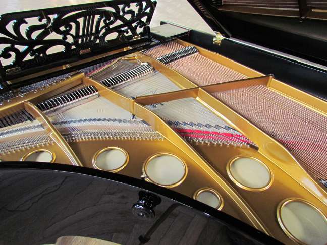 Bosendorfer grand piano in black, view of soundboard